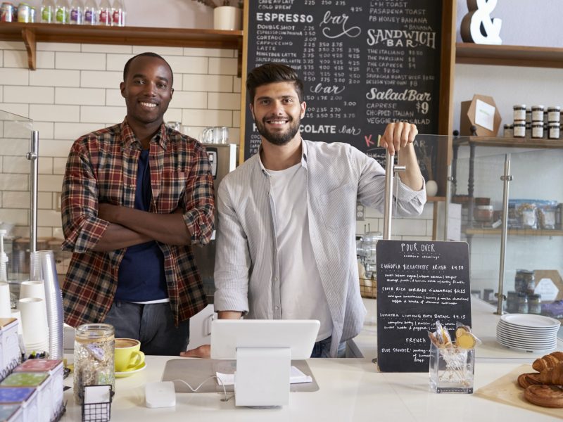 Business partners at the counter of a coffee shop, close up